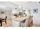 Bright kitchen with white cabinetry, granite countertops, stainless appliances and bar seating at 3612 Wexford Ln, Sarasota, FL 34233