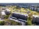 Stunning aerial view of the condo building overlooking a lush golf course with ponds and mature trees at 3620 Ironwood Cir # 606, Bradenton, FL 34209