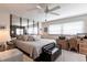 Bright bedroom with a ceiling fan, desk, bench and large mirror wall, perfect for a home office at 3620 Ironwood Cir # 606, Bradenton, FL 34209