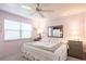 Cozy bedroom featuring a ceiling fan, large window, and comfortable queen-sized bed at 3620 Ironwood Cir # 606, Bradenton, FL 34209