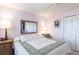 Comfortable bedroom featuring a ceiling fan, large window, and comfortable queen-sized bed at 3620 Ironwood Cir # 606, Bradenton, FL 34209
