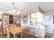 Comfortable dining area featuring wood floors, a chandelier and a kitchen view at 3620 Ironwood Cir # 606, Bradenton, FL 34209
