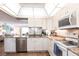Updated kitchen with white cabinets, granite counters, stainless appliances, and wood-look floors at 3620 Ironwood Cir # 606, Bradenton, FL 34209
