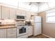 Bright kitchen featuring granite counters, white appliances, and ample cabinet space at 3620 Ironwood Cir # 606, Bradenton, FL 34209