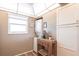 Functional laundry area with stacked washer/dryer and extra storage cabinets at 3620 Ironwood Cir # 606, Bradenton, FL 34209