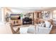 Comfortable living area with entertainment center and views of dining area and outdoor balcony at 3620 Ironwood Cir # 606, Bradenton, FL 34209