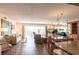 Open-concept living and dining area features wood flooring and access to a balcony with expansive views at 3620 Ironwood Cir # 606, Bradenton, FL 34209