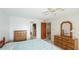 Bright bedroom with ceiling fan, wood furniture, and adjacent doorway, offering natural light and ample space at 3763 Lake Bayshore Dr # 310, Bradenton, FL 34205
