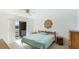 Bedroom with natural light, balcony access and light blue bed linens, showcasing a relaxing space at 3763 Lake Bayshore Dr # 310, Bradenton, FL 34205