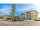 A multi-story residential building boasts well-maintained landscaping and ample parking at 3763 Lake Bayshore Dr # 310, Bradenton, FL 34205