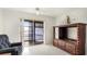 Living room featuring a dark entertainment center and a glass sliding door to a balcony at 3763 Lake Bayshore Dr # 310, Bradenton, FL 34205