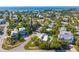 Aerial view of a neighborhood with mature trees, lush landscaping, and beautiful waterfront views at 414 79Th St, Holmes Beach, FL 34217