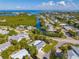 Waterfront community aerial view with canal, beach, and lush greenery at 414 79Th St, Holmes Beach, FL 34217