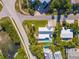 Aerial view of home featuring white exterior, in ground pool and lush landscaping at 414 79Th St, Holmes Beach, FL 34217