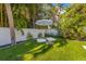 Cozy backyard relaxation spot with comfortable cushions and an umbrella, perfect for relaxing and enjoying the outdoors at 414 79Th St, Holmes Beach, FL 34217