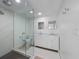 Modern bathroom features a glass walk-in shower and dual sink vanity with marble countertops at 414 79Th St, Holmes Beach, FL 34217