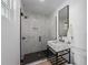 Bright bathroom featuring a modern vanity, a glass walk-in shower, and sleek black hardware at 414 79Th St, Holmes Beach, FL 34217