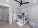 Charming bedroom featuring a bunk bed, hardwood floors, ample natural light, and a coastal-style theme at 414 79Th St, Holmes Beach, FL 34217