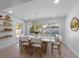 Bright dining room features a modern table with seating, stylish light fixture, and views of the pool at 414 79Th St, Holmes Beach, FL 34217