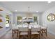 Bright dining room features a modern table with seating, stylish light fixture, and views of the pool at 414 79Th St, Holmes Beach, FL 34217