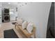 Beautiful entryway featuring a modern bench, laundry area, hardwood floors, and stylish decor at 414 79Th St, Holmes Beach, FL 34217