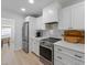 Close up of kitchen features modern appliances, and white countertops with tile backsplash at 414 79Th St, Holmes Beach, FL 34217