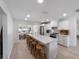 Modern kitchen features an island with seating, stainless appliances, and ample cabinet space at 414 79Th St, Holmes Beach, FL 34217