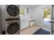 Well-equipped laundry room featuring modern washer and dryer, white cabinets, and a built-in desk area at 414 79Th St, Holmes Beach, FL 34217
