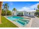 Backyard oasis with in ground pool, inground hot tub, and loungers at 414 79Th St, Holmes Beach, FL 34217