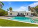 Inviting backyard showcasing a sparkling pool, stylish lounge chairs, and a well-manicured lawn for relaxation at 414 79Th St, Holmes Beach, FL 34217