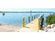 Wooden dock in a waterfront property, with lovely water and nature views under a sunny sky at 4404 5Th W Ave, Palmetto, FL 34221