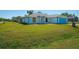 Charming single-story home with a lush front yard, freshly cut grass and colorful door at 4404 5Th W Ave, Palmetto, FL 34221