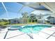 Sparkling screened pool featuring a relaxing spa and outdoor lounging area at 4404 5Th W Ave, Palmetto, FL 34221