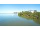 Waterfront property featuring lush greenery and serene water views on a sunny day at 4404 5Th W Ave, Palmetto, FL 34221