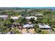 Aerial shot of home and property, featuring pool, landscaping, and architecture, near a neighborhood park at 448 58Th St, Sarasota, FL 34243