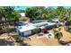 Single-story home with a flat roof, manicured lawn, and a paved patio area at 448 58Th St, Sarasota, FL 34243