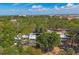 Gorgeous aerial shot of a spacious home with a pool, lush trees, and city views in the background at 448 58Th St, Sarasota, FL 34243