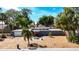 Charming single-story home with a well-manicured lawn and mature trees, captured from an aerial perspective at 448 58Th St, Sarasota, FL 34243