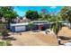 Well-maintained single-story home with mature trees and a manicured lawn, seen from an aerial perspective at 448 58Th St, Sarasota, FL 34243