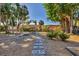 Landscaped backyard with a stone pathway, patio furniture, and mature trees offering plenty of shade at 448 58Th St, Sarasota, FL 34243