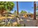 Outdoor seating area with mature trees, screened-in pool, creating a peaceful and inviting atmosphere at 448 58Th St, Sarasota, FL 34243
