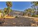 Screened-in pool surrounded by lush landscaping, offering a private and relaxing outdoor oasis at 448 58Th St, Sarasota, FL 34243