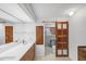Bathroom showcasing double sinks, a barn door, and a toilet in a separate area at 448 58Th St, Sarasota, FL 34243