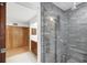 Bathroom with a tiled shower, double sinks, and a view to an attached closet at 448 58Th St, Sarasota, FL 34243