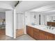Bathroom with double sinks, wood cabinets, and bright lighting at 448 58Th St, Sarasota, FL 34243