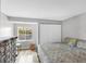 Bright bedroom with natural light, hardwood floors, and a view to the backyard at 448 58Th St, Sarasota, FL 34243