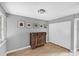 This gray bedroom includes an antique trunk, wood floor, decor, and a double door closet at 448 58Th St, Sarasota, FL 34243