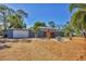 Charming single-story home with a flat roof, attached garage, and a neatly landscaped front yard at 448 58Th St, Sarasota, FL 34243