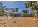 Charming single-story home with a modern design, complemented by a well-maintained yard and lush trees at 448 58Th St, Sarasota, FL 34243