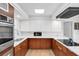 Bright kitchen with stainless steel appliances, white cabinets, and skylight providing natural light at 448 58Th St, Sarasota, FL 34243